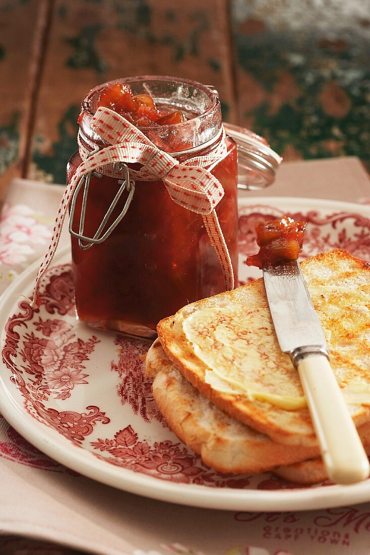 A jar of rhubarb jam and a slice of toast