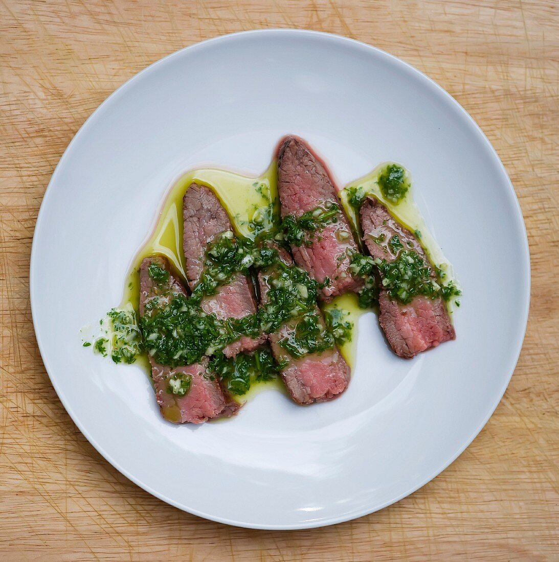 Sliced Steak Topped with Chimichurri Sauce