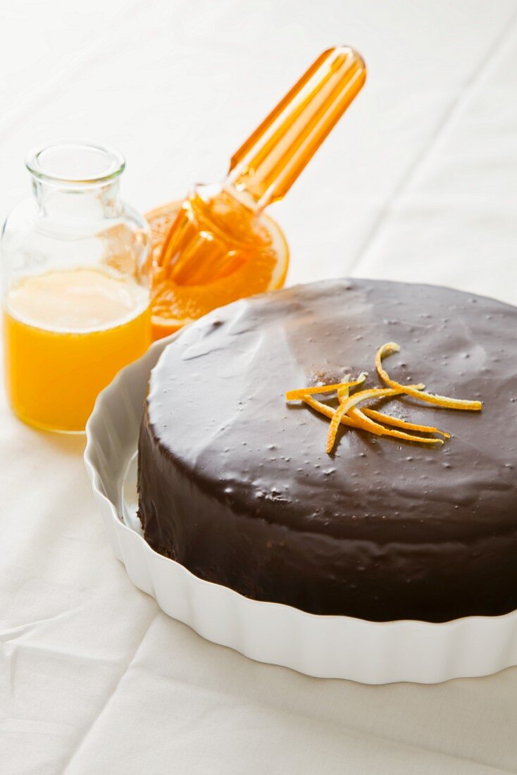 An orange and nut tart topped with chocolate glaze