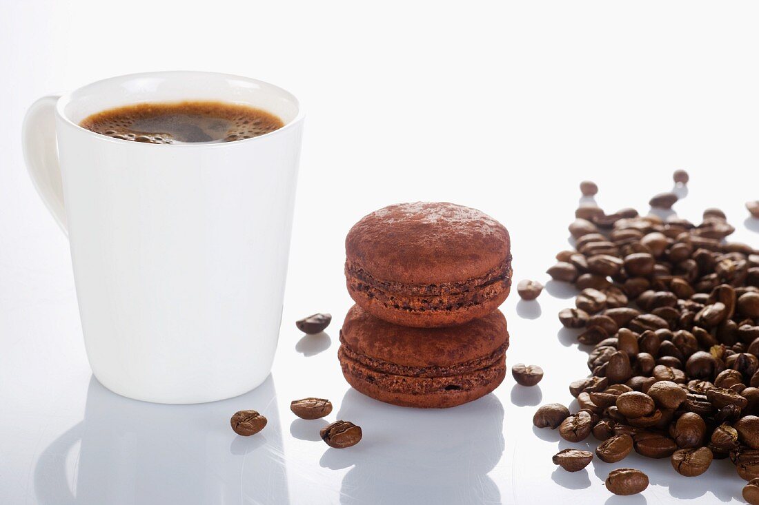A cup of coffee and chocolate macaroons