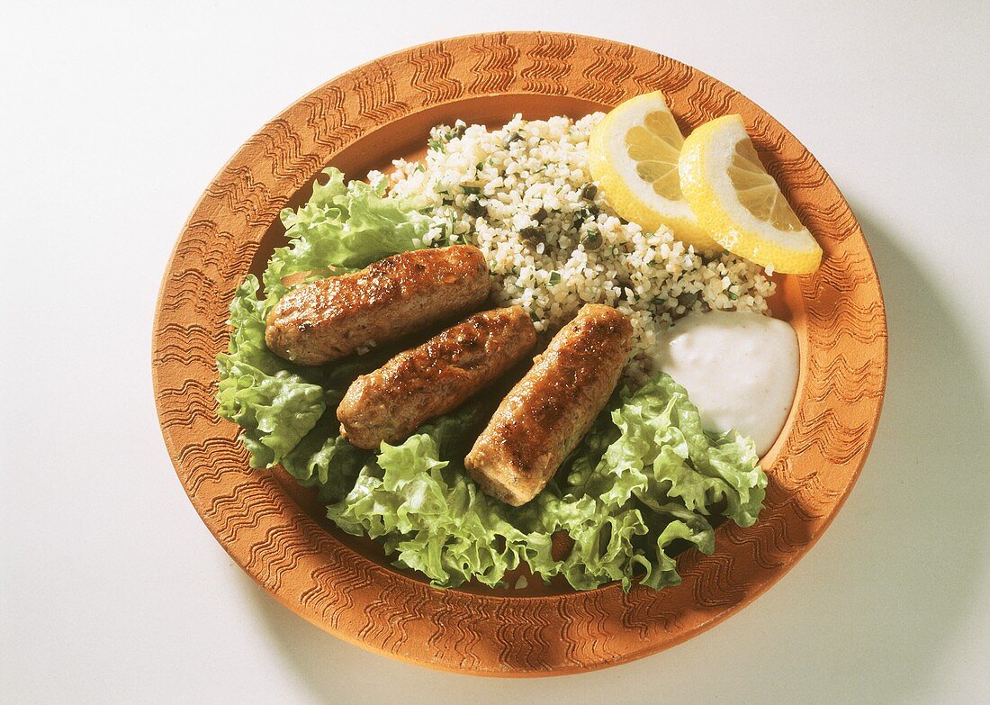 Ground lamb sausage on curly endive with rice