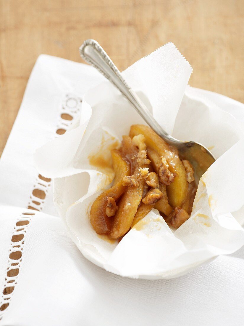 Baked peach wedges with nuts in parchment paper