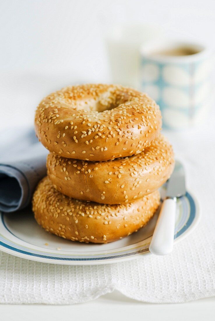 Drei Sesambagels auf Teller, gestapelt