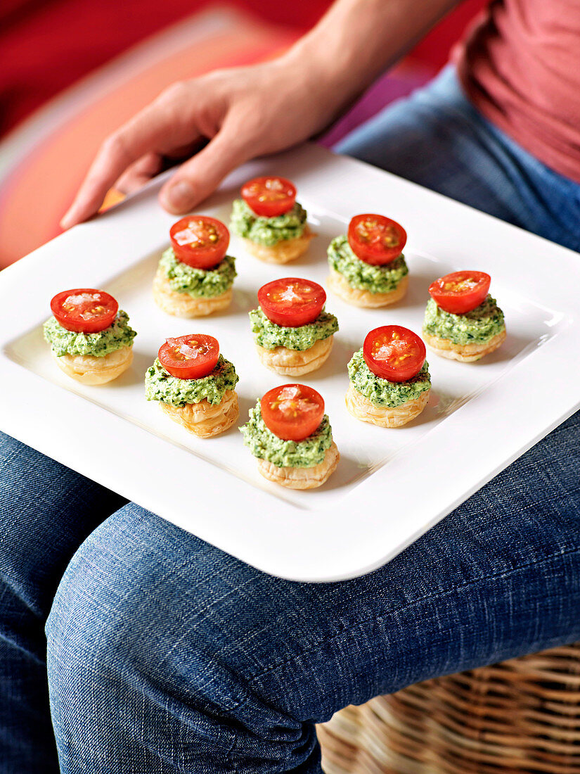Puff pastry canapes with feta cheese pesto and cherry tomatoes