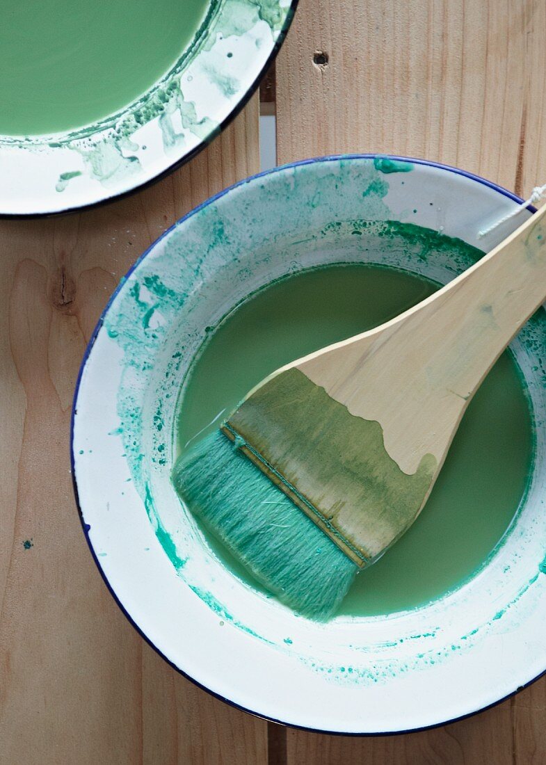 Green paint and paintbrush