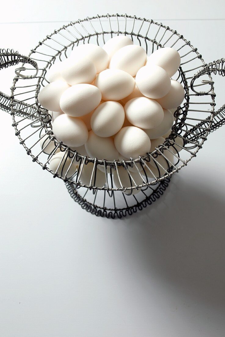 Organic White Eggs in a Wire Basket; From Above
