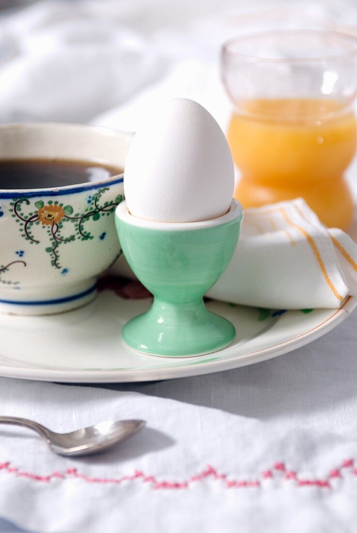 Breakfast of Hard Boiled Egg with a Glass of Orange Juice and Cup of Coffee