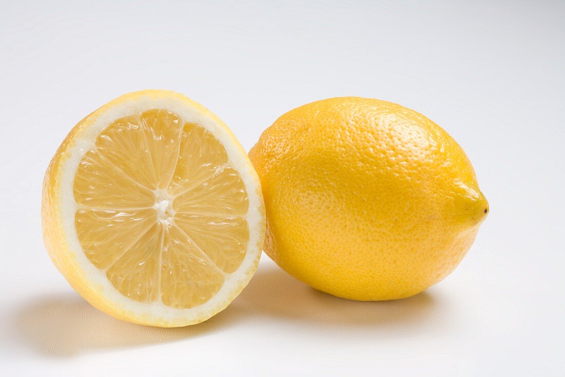 Half and Whole Lemon on White Background