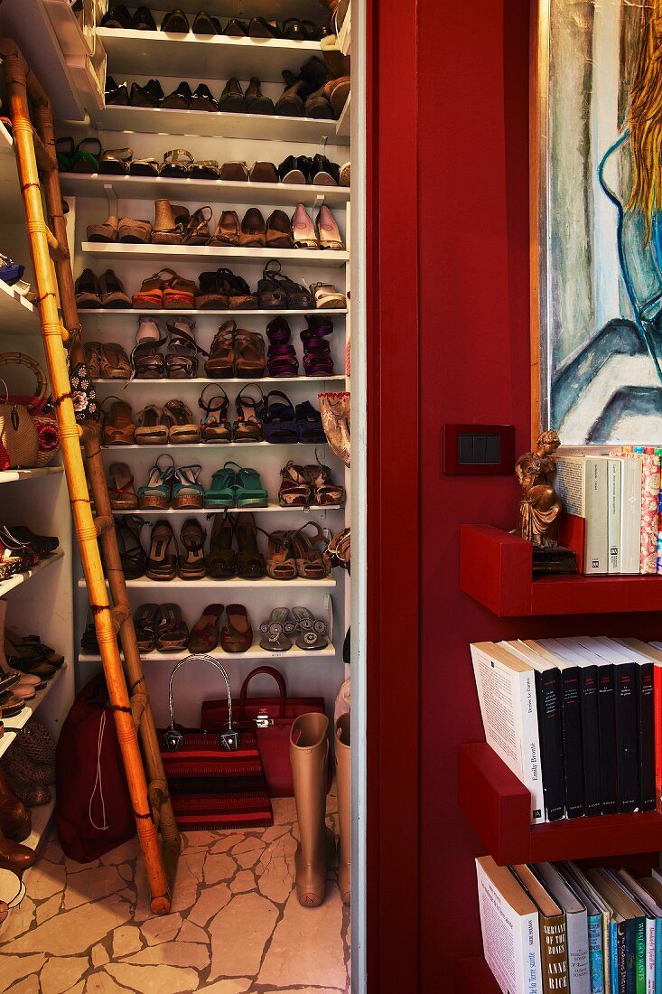 Ladies' shoes on floor-to-ceiling white shelving in niche