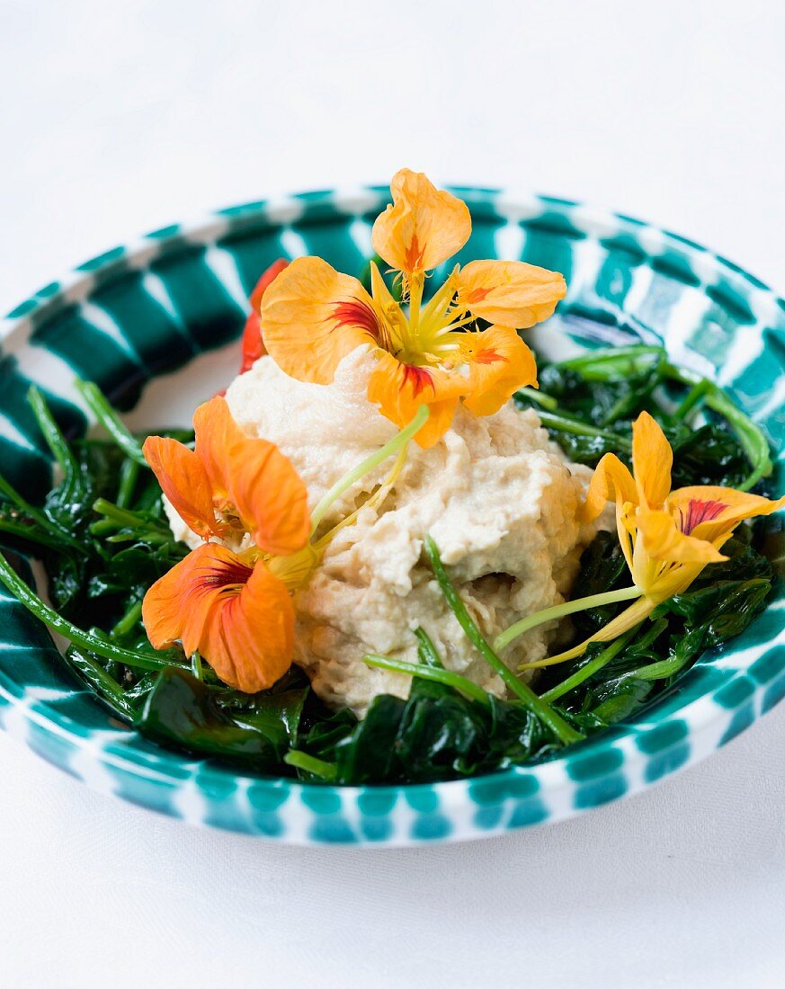 Smoked fish cream with baby spinach and nasturtium flowers