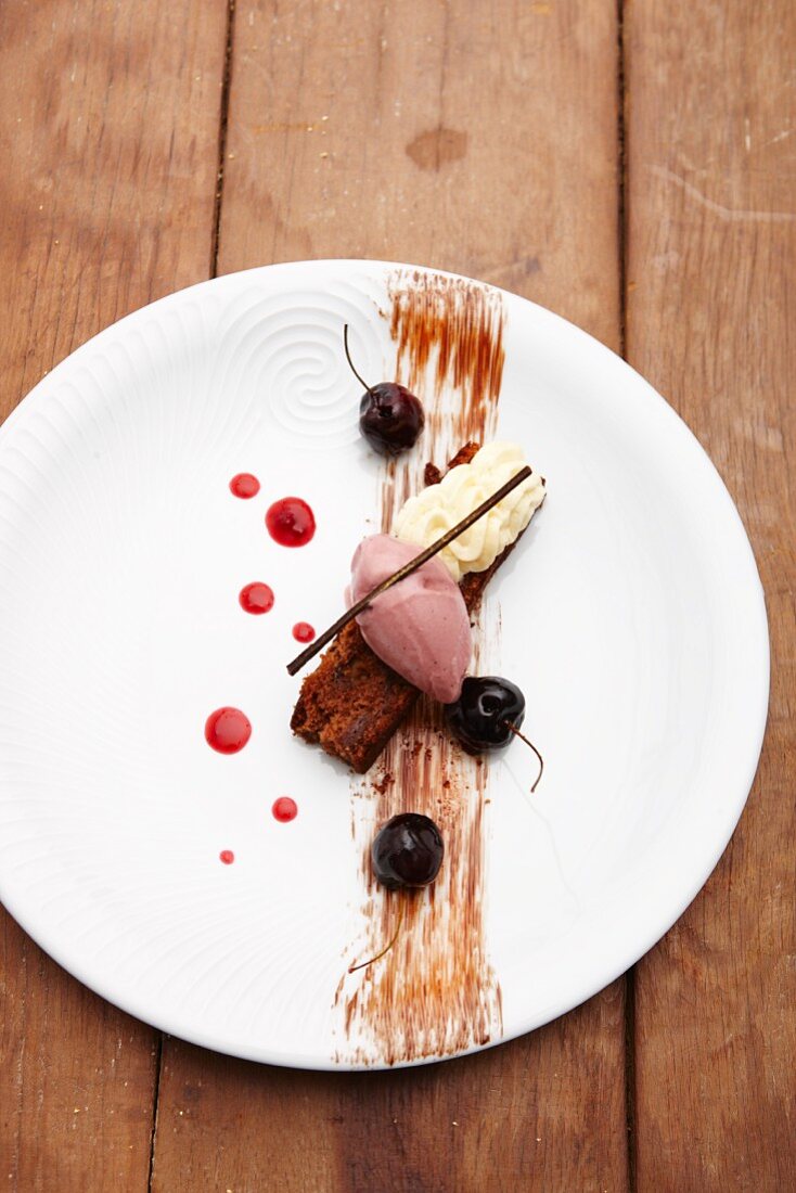 A desert composition with cherry ice cream on sponge cake