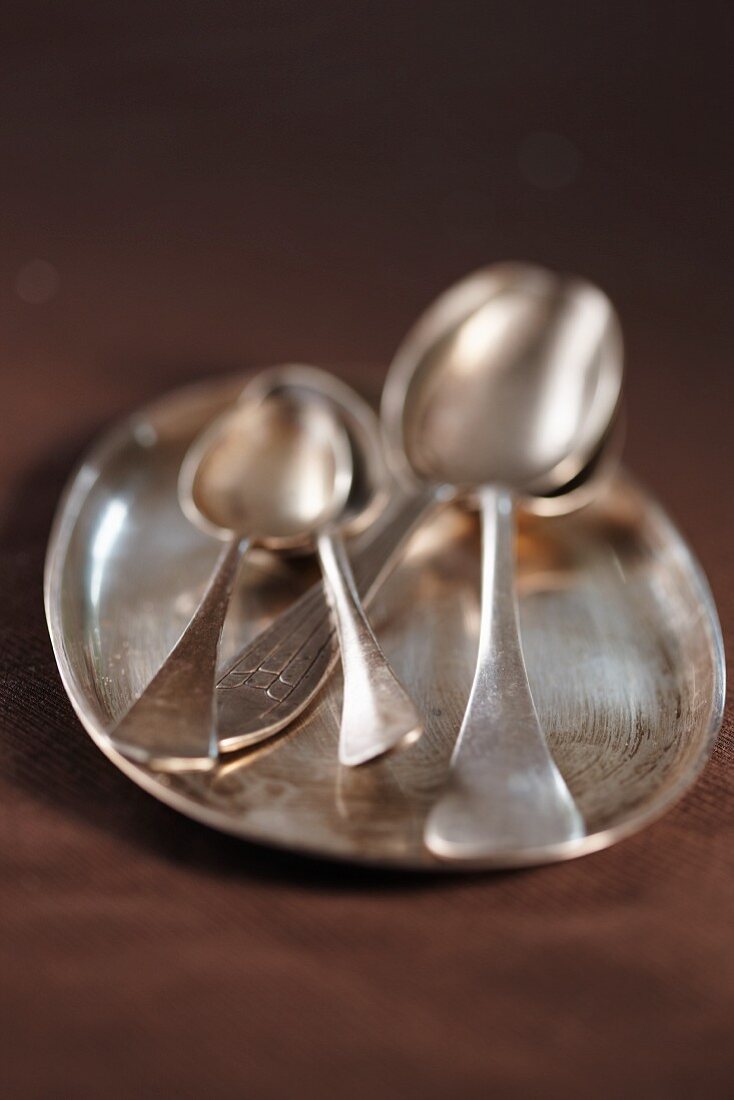Silver spoons on a silver tray