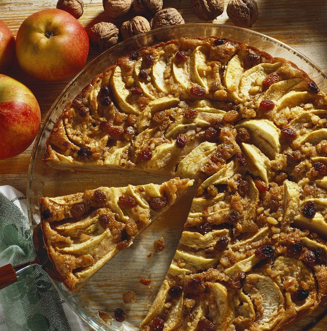 Apple tart with walnuts & raisins on glass platter