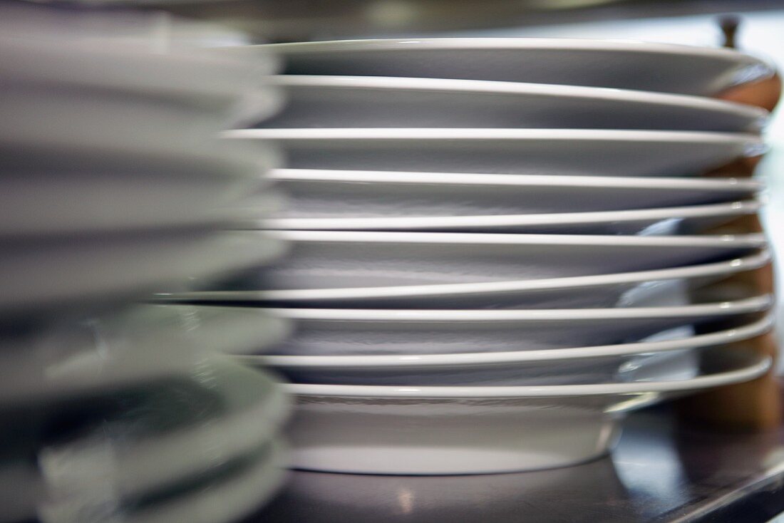 A stack of plates in a commercial kitchen