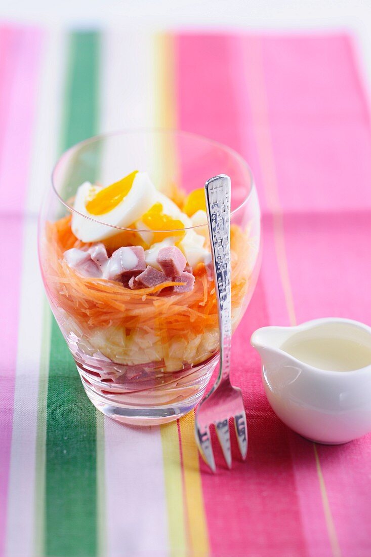 A layered salad with vegetables and egg
