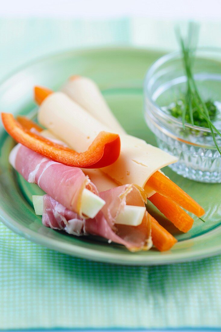 Cheese and ham rolls with vegetable sticks