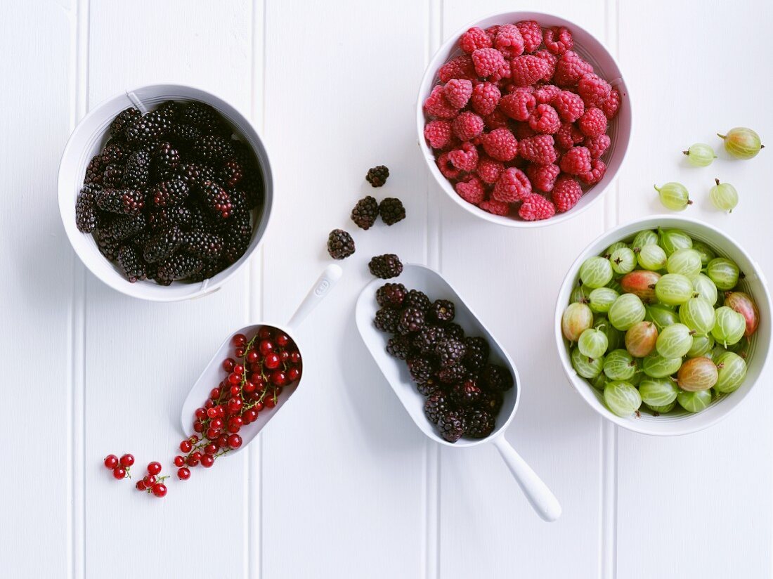 Various berries in bowls, seen from above