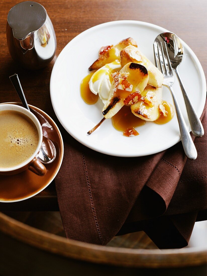 Fried pears with caramel sauce and a cup of coffee
