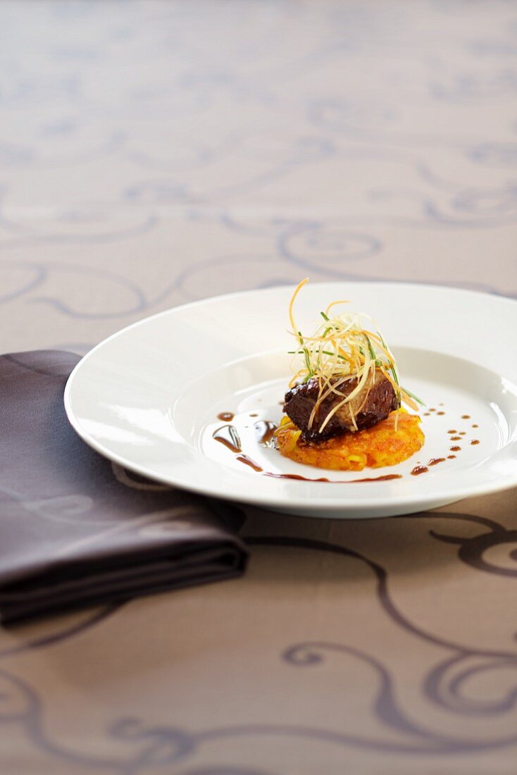 Veal cheeks on a fried potato cake