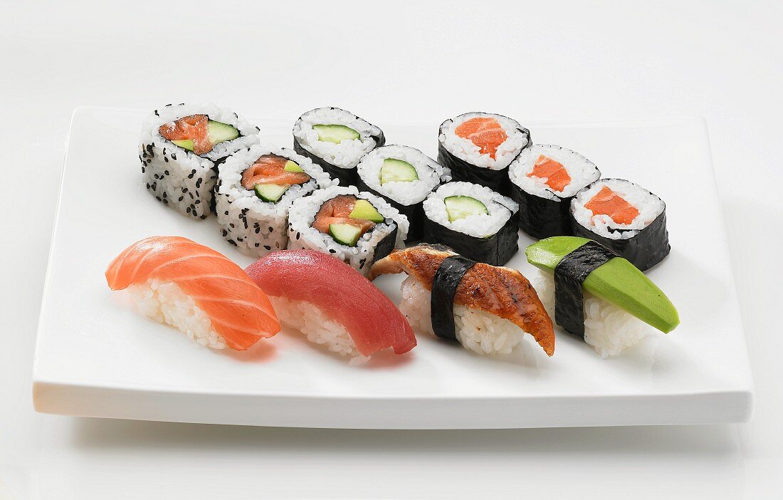 A sushi platter with maki, nigiri and inside out rolls