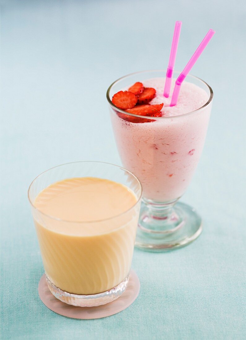 A strawberry smoothie and a peach yogurt drink
