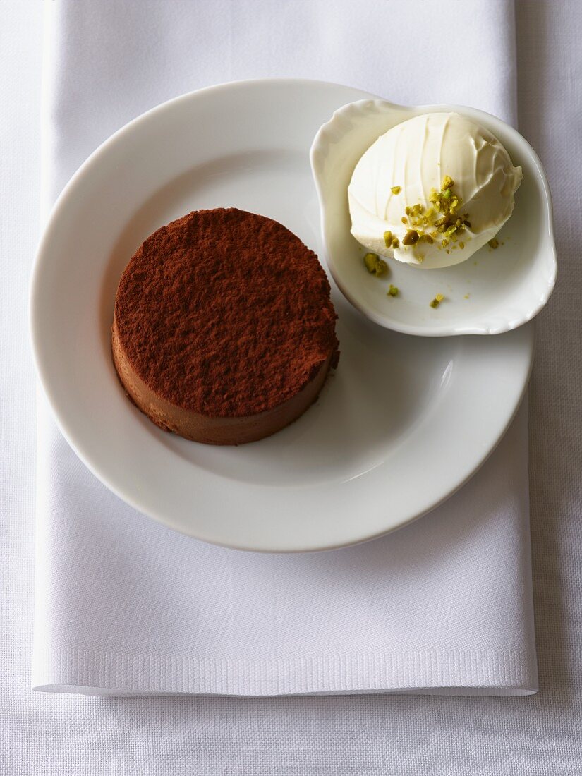 Chocolate cake with ice cream and pistachios