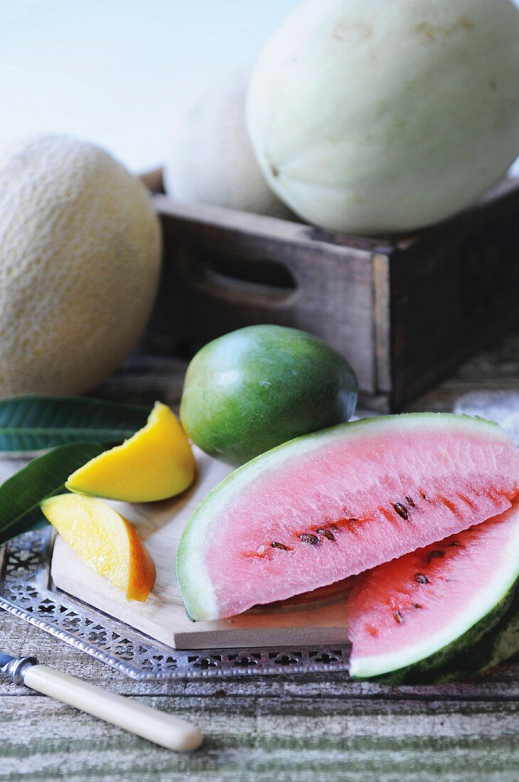 An arrangement of melons and mangos