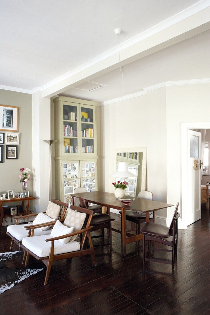 Open-plan living-dining room with dark table and seating