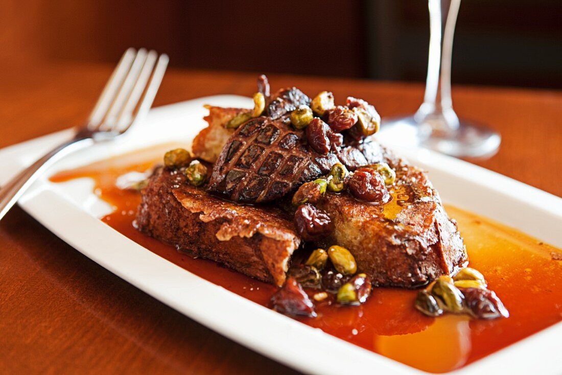 Brioche Toast Topped with Pan Seared Foie Gras, Pistachios, and Poached Cherries