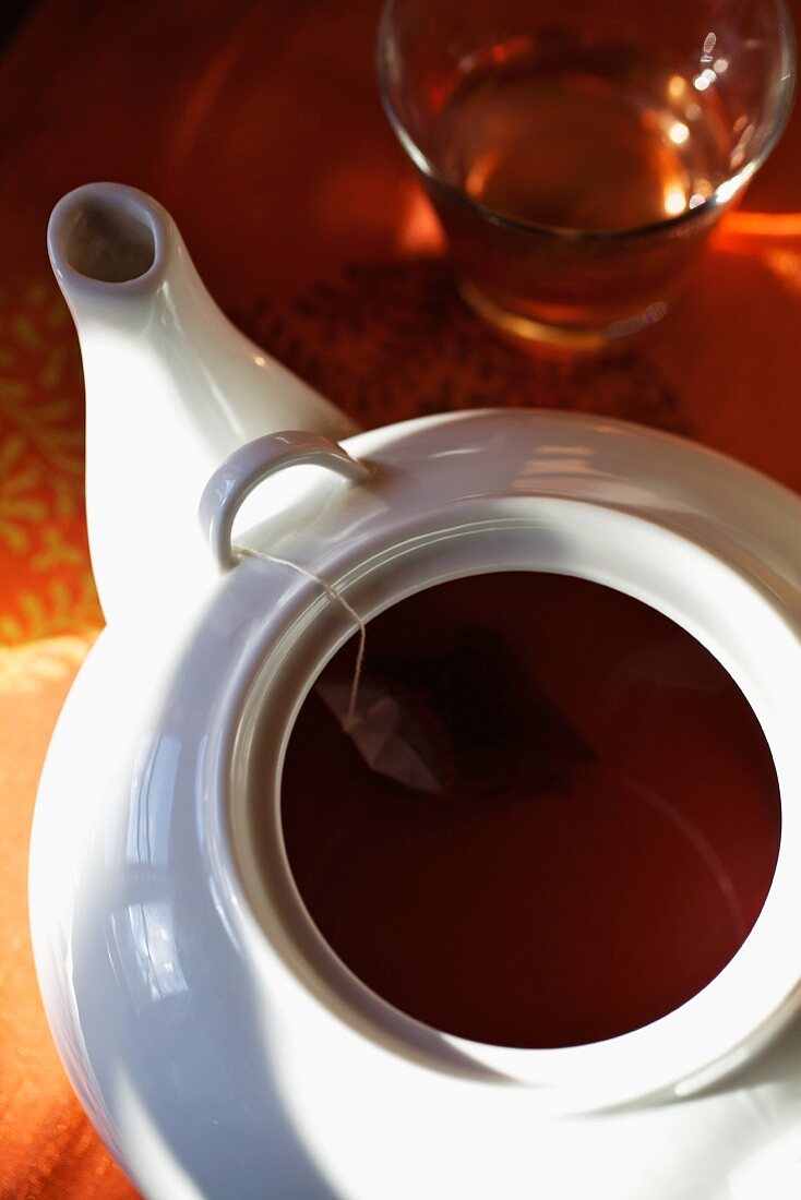 A fruit tea bag in a teapot