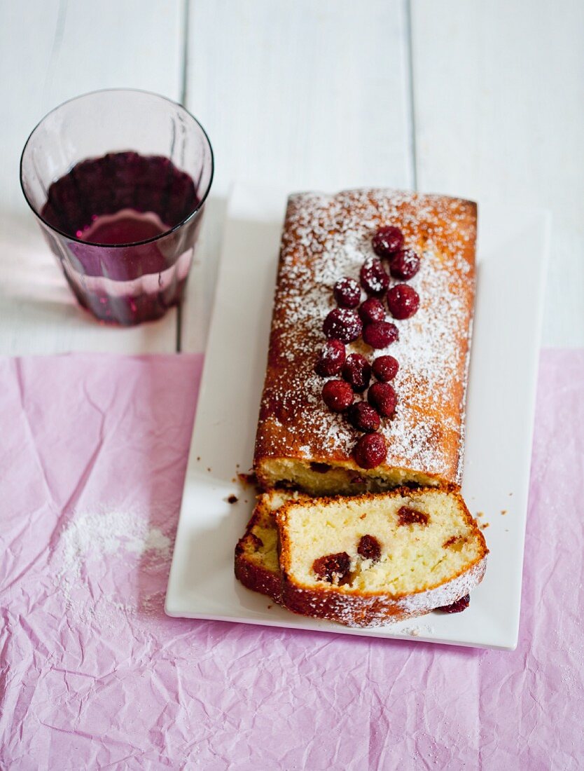 A loaf cake with cranberries, sliced