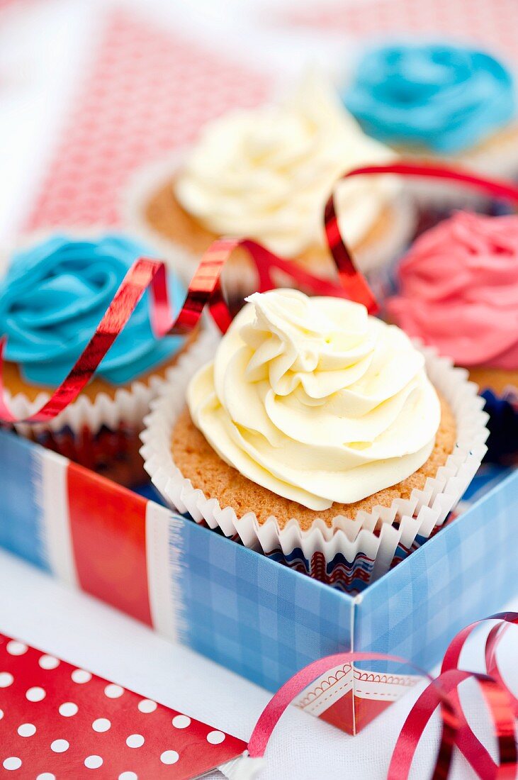 Mini cupcakes topped with different coloured frosting