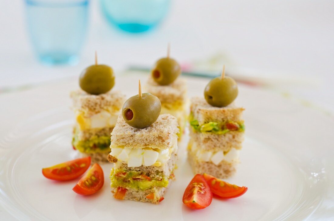 Sandwiches on sticks with olives, avocado and egg (Dominican Republic)