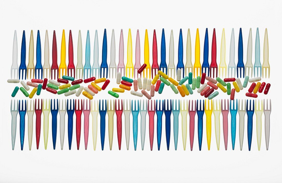 Rows of colourful pills and plastic forks