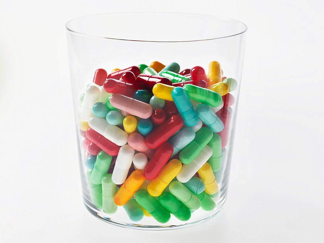 A glass of colourful tablets