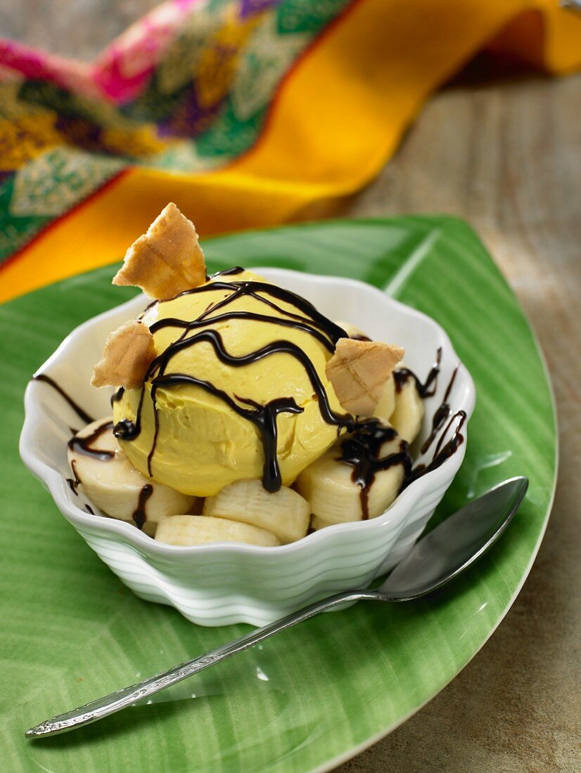 Mango ice cream with banana and chocolate sauce