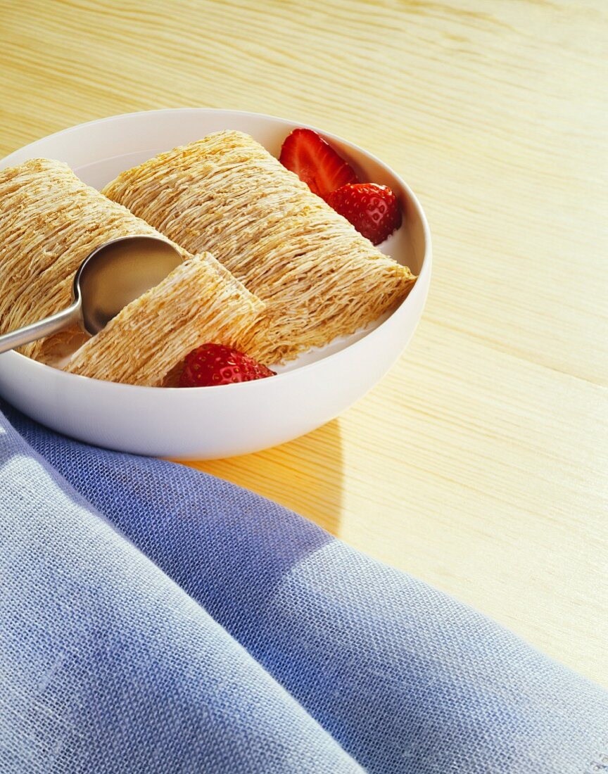 Bowl of Shredded Wheat Cereal with Milk and Fresh Strawberries