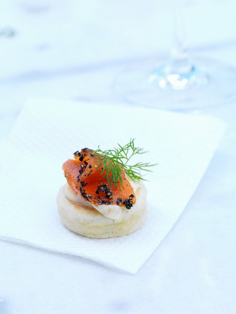 A sponge cake canape topped with smoked salmon