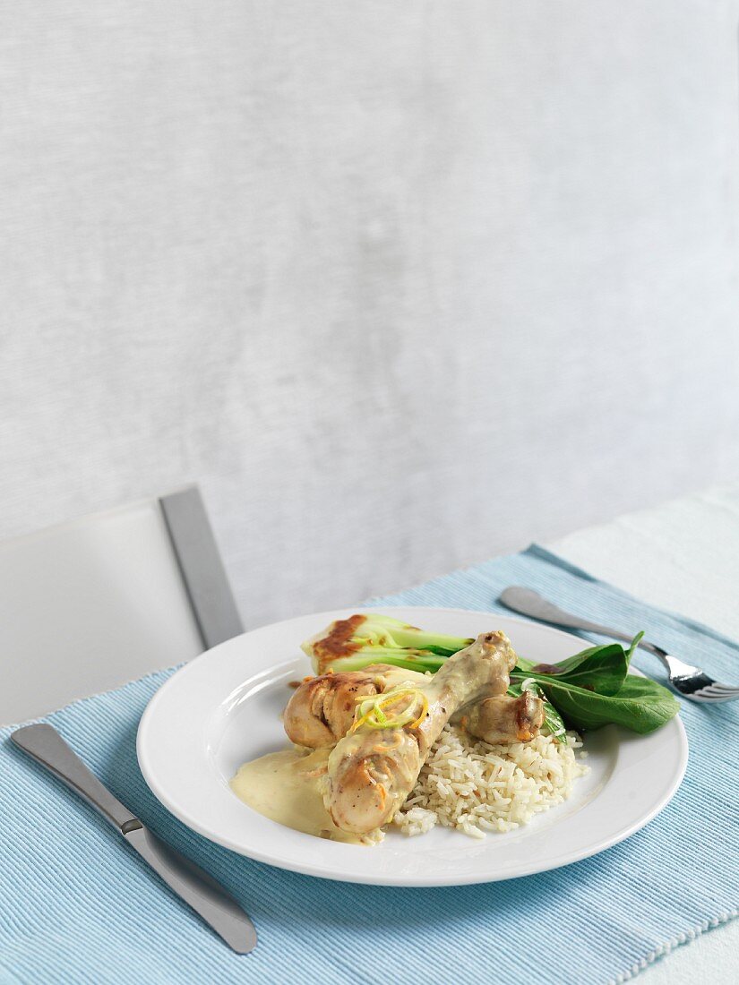 Marinated chicken legs with a creamy sauce and rice