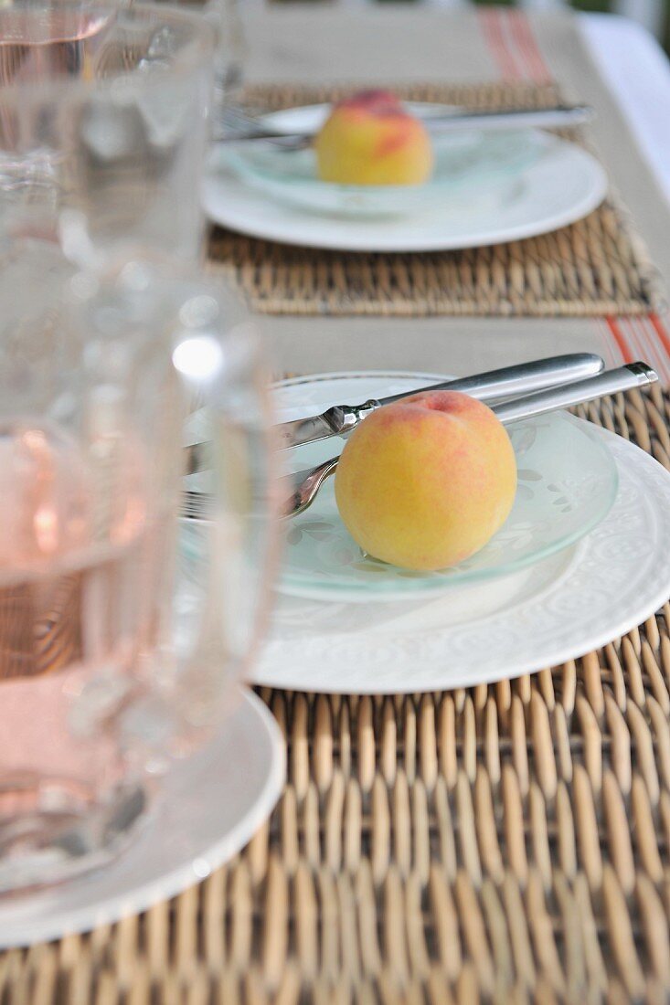 Place settings with fresh peaches