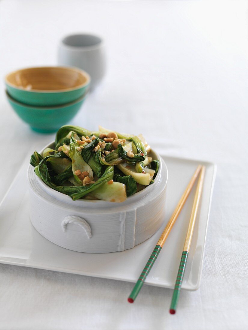 Steamed bok choy with chopped peanuts
