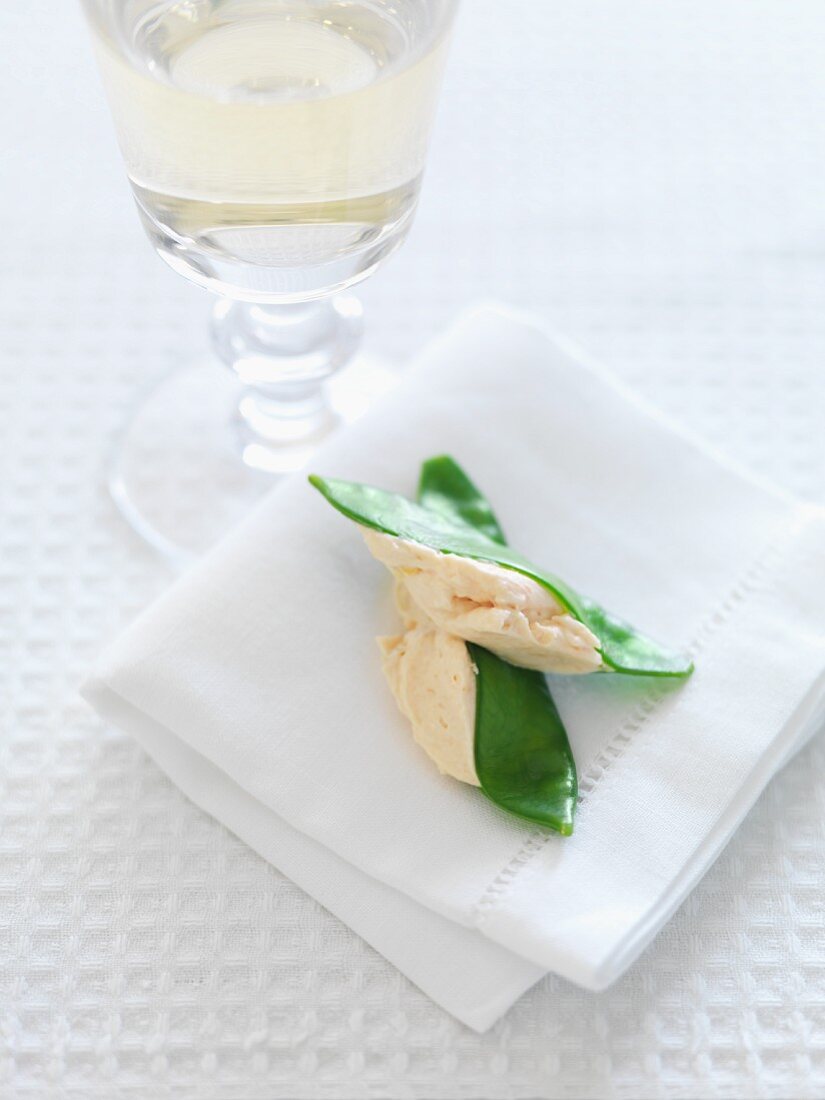Salmon cream on mange tout with a glass of white wine
