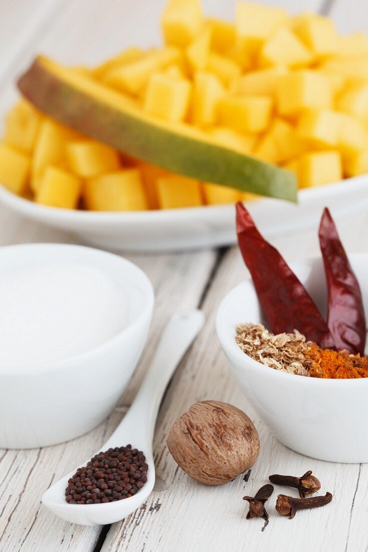 Ingredients for mango chutney: mango, chilli peppers, sugar, nutmeg, cloves, mustard seeds, turmeric, cumin