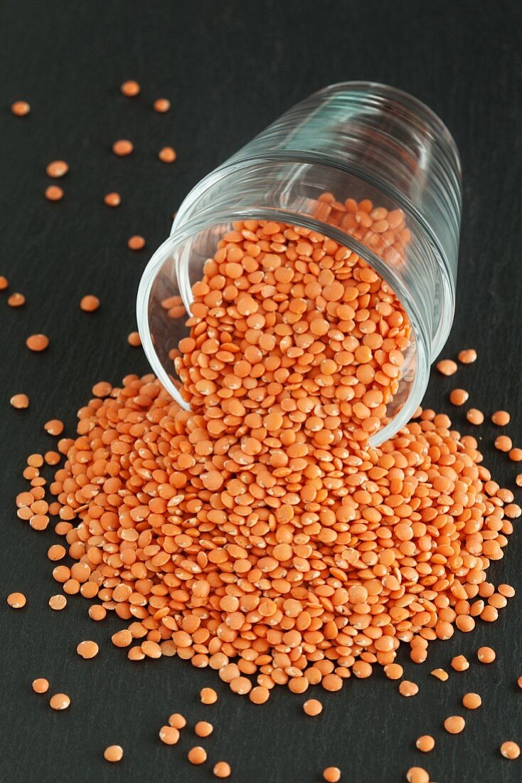 Red lentils falling out of a jar