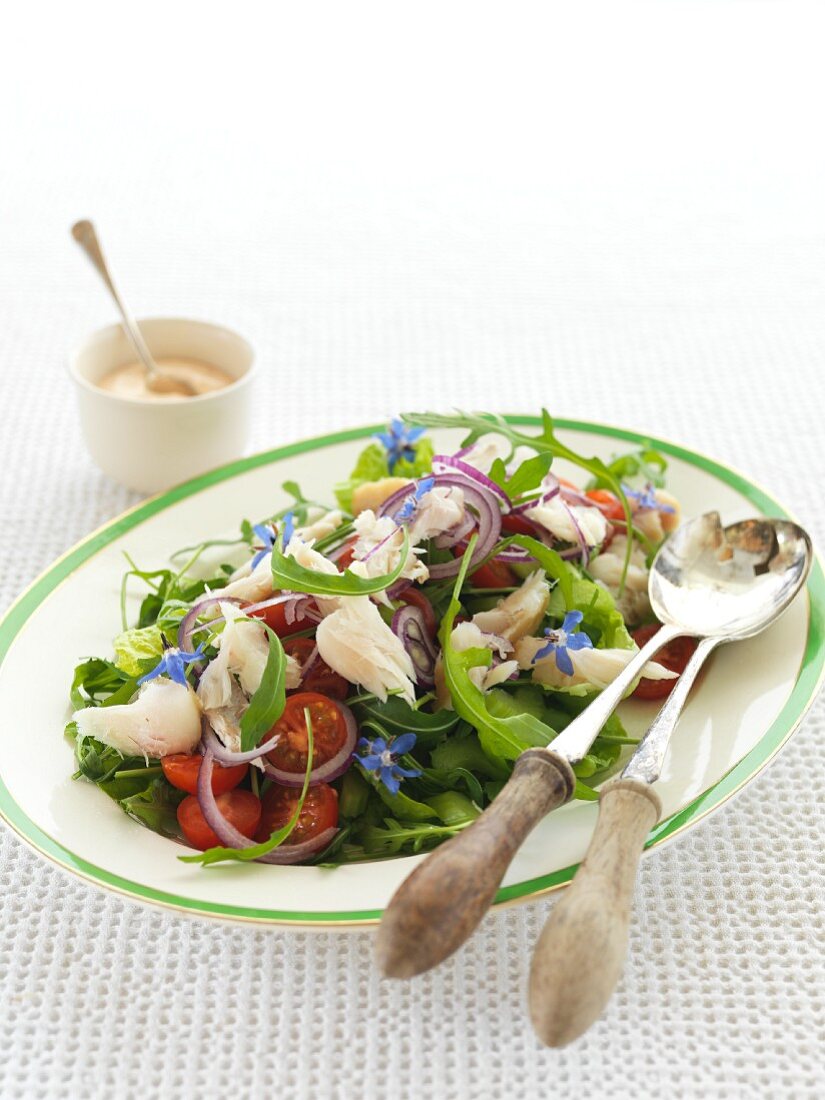 Rocket salad with smoked fish and borage flowers