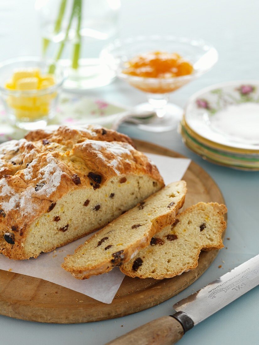 Sliced soda bread with raisins on a wooden board