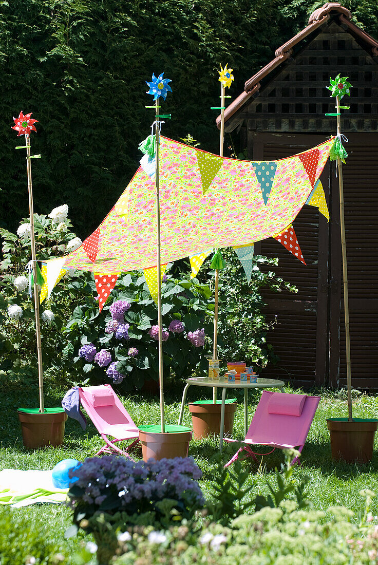 Colorful garden party decoration with pennant chain and awning