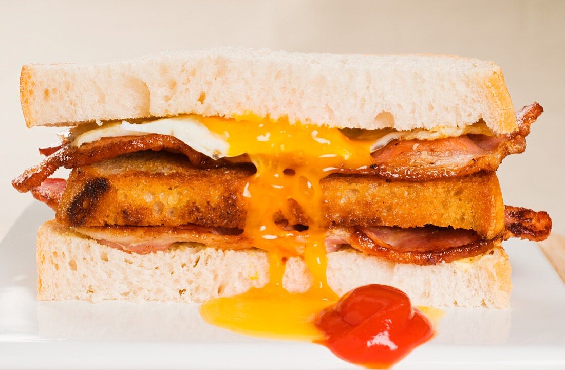 A toasted bacon, fried egg and cheese sandwich