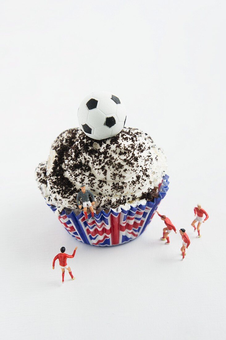 A cupcake with cream and football decoration (Great Britain)