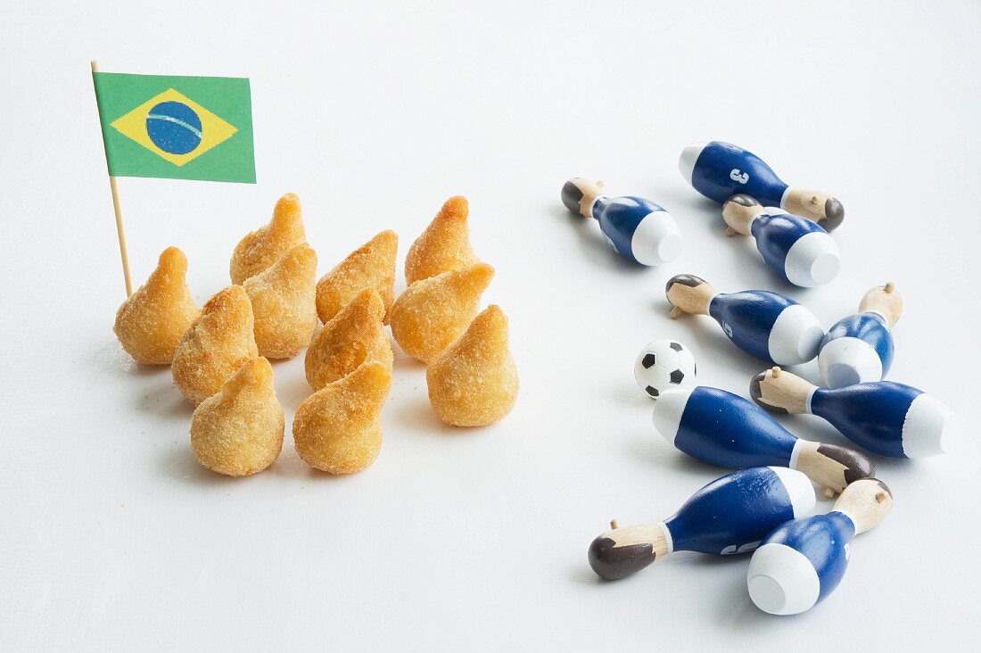 Salgadinhos with a Brazilian flag and football decorations